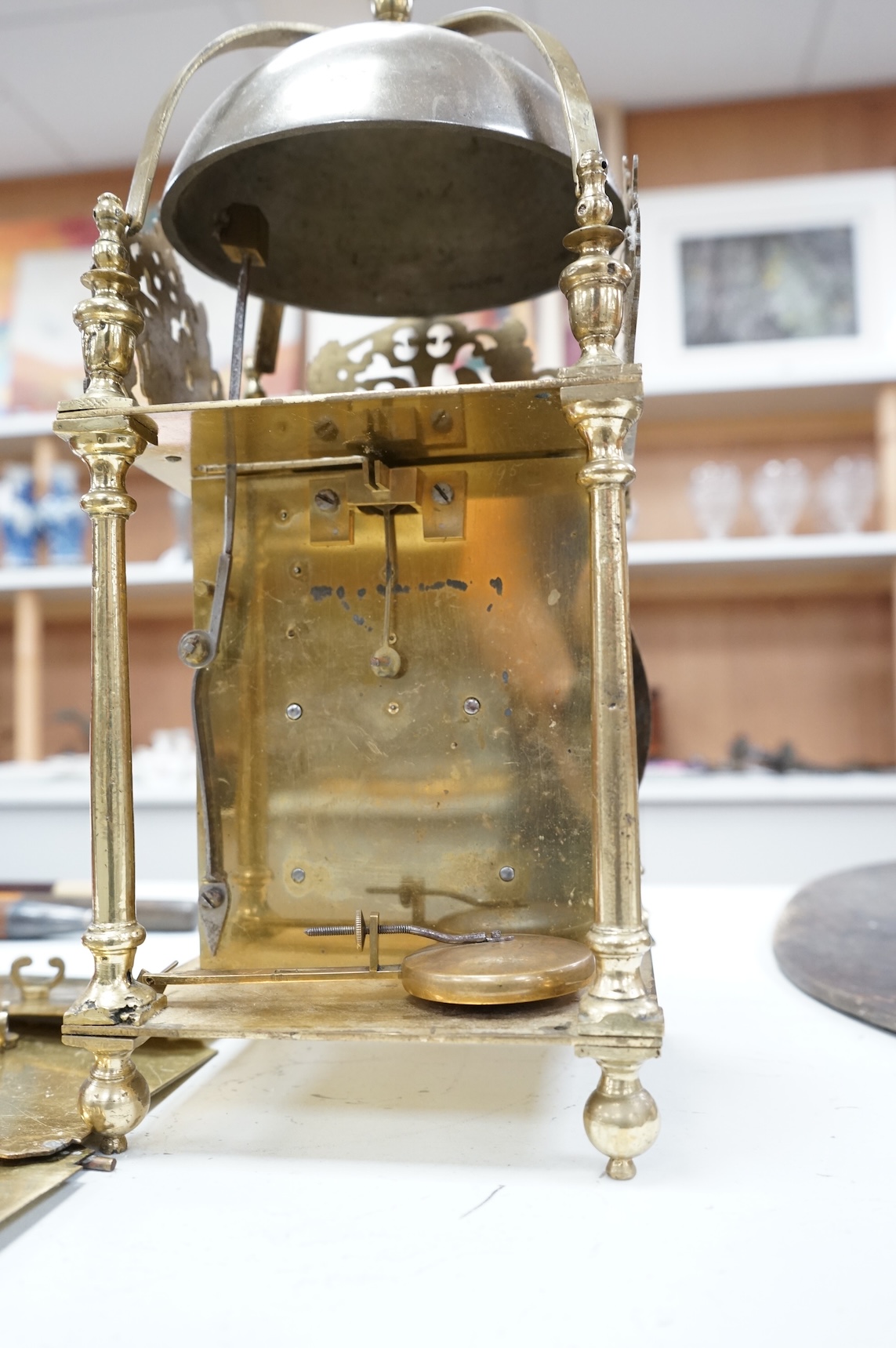 A twin fusee brass lantern clock, 38cm high.